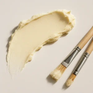 Shea butter in a wooden bowl with natural elements on a rustic surface, symbolizing the philosophy of slow skincare and the patience required for long-term beauty results